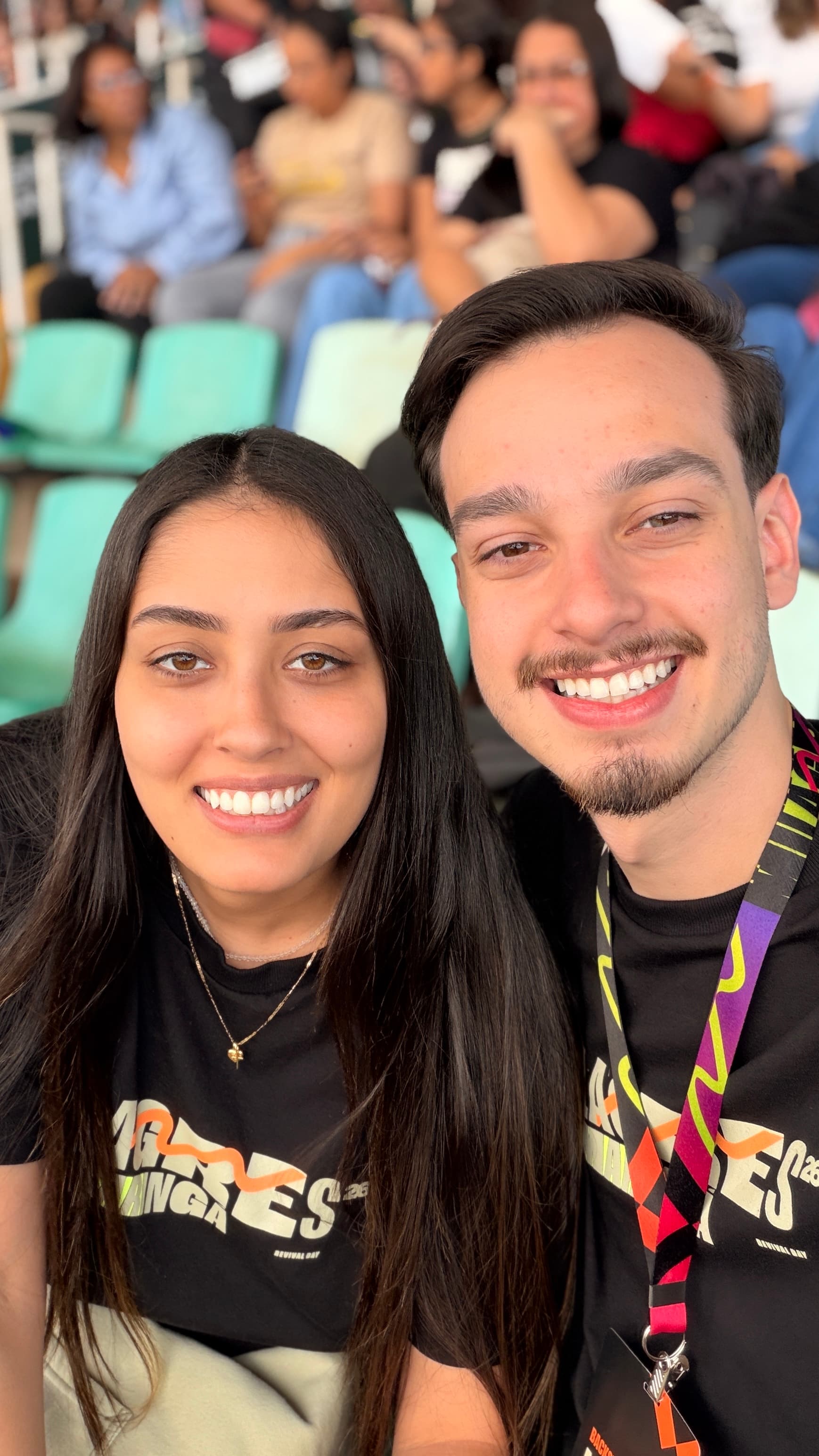 Pedro and his partner smiling together in the stands