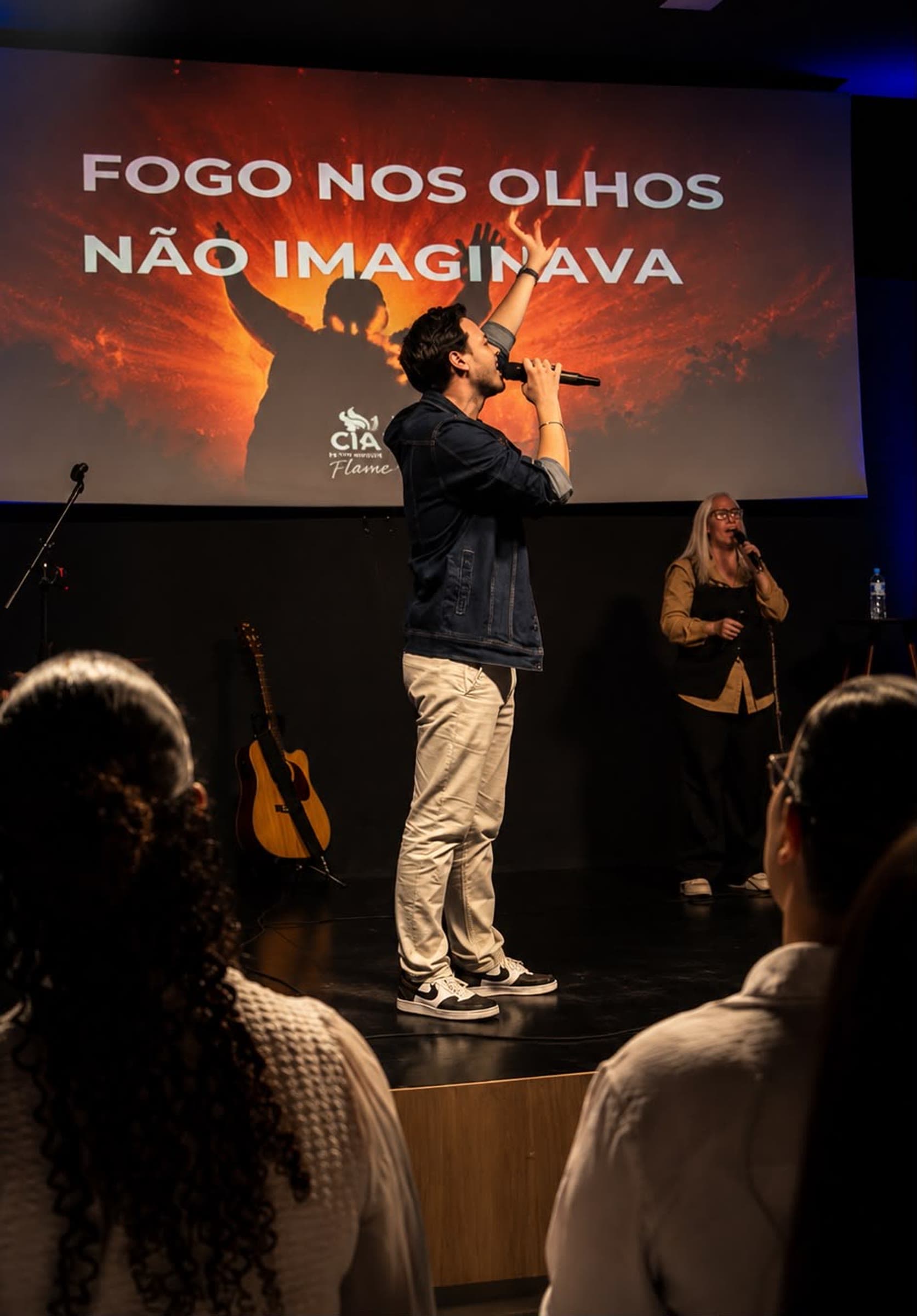 Pedro singing and ministering on the Flame stage